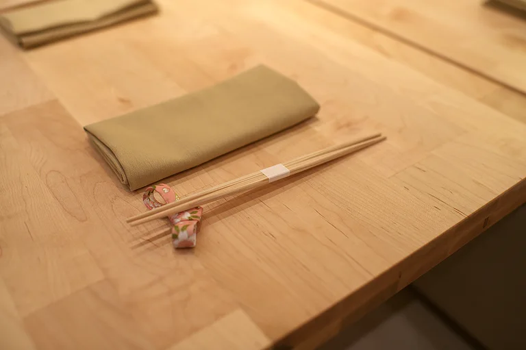 A folded napkin and chopsticks awaiting a guest